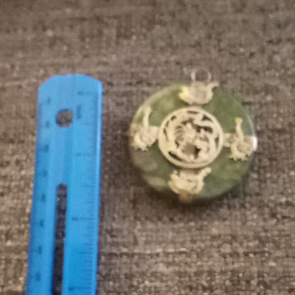 Jade pendant.  Detail is silver